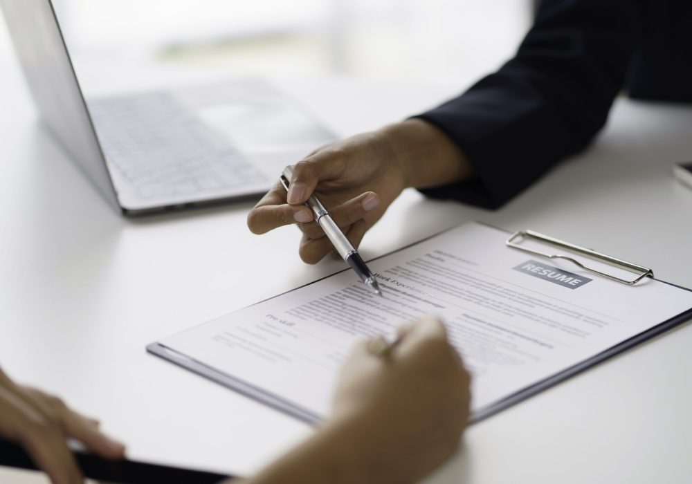 New graduate woman filling out an application form for HR department Review and review your educational background and interview details.